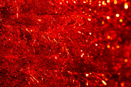 Tinsel Garland Background, Red Defocused Lights, Abstract Decoration Ribbon Blur, Closeupの写真素材