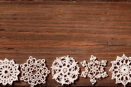 Snowflakes Wood Background, Christmas Lace Snow Flakes, Wooden Embroidered Holiday Ornamentの写真素材