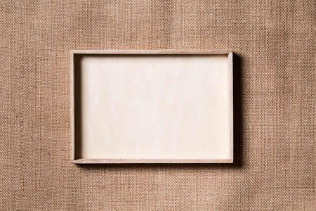 Burlap Frame, Wooden Border over Sack Cloth Background, Wood Frames on Fabric Textureの写真素材