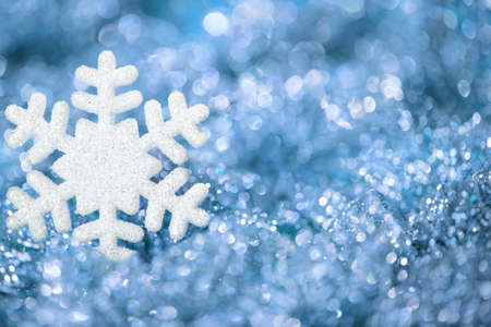 Snowflake Blue Background, Sparkling Snow Flakes Decoration over Defocused Lights Backgroundの写真素材