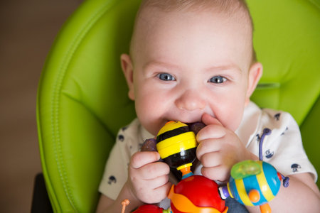 Happy Baby, Cute Infant Kid Playing with Teether Toy, Smiling Boy Portrait, Seven Months Old