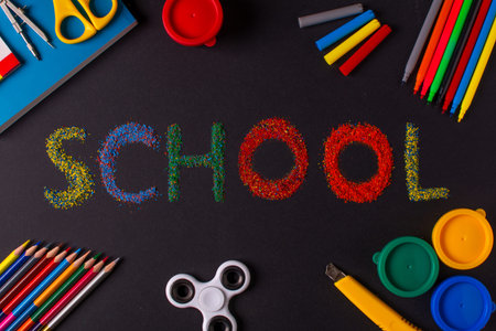 school supplies on the background of a blackboard