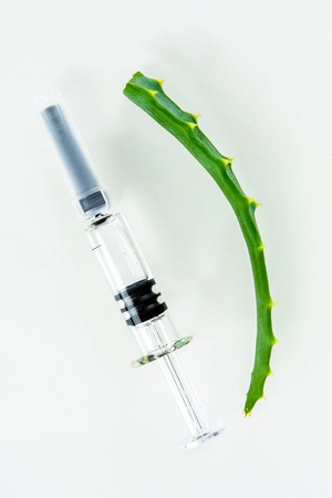 syringe with vitamins on a white backgroundの写真素材