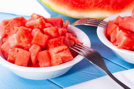 Watermelon cut into cubes on a plateの写真素材