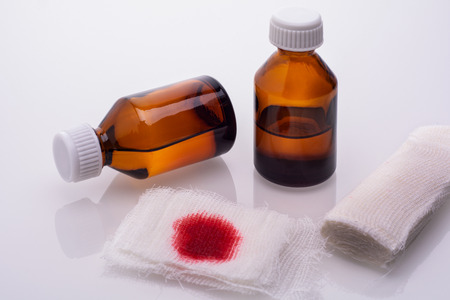 gauze napkin in the blood and two vials with hydrogen peroxideの写真素材