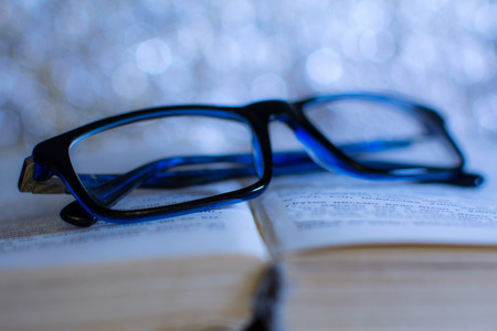 blue glasses on the bookの写真素材