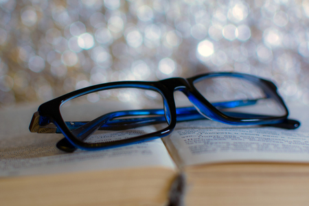 glasses on the bookの写真素材