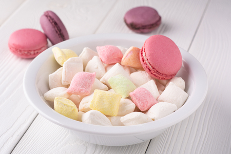 colorful candy and macaroni on a white tableの写真素材