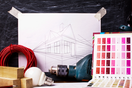 concept of home improvement. a set of tools and a drawing of the houseの写真素材
