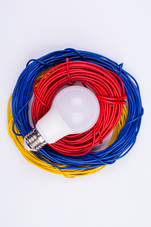 rolls of electric wires with a light bulbの写真素材