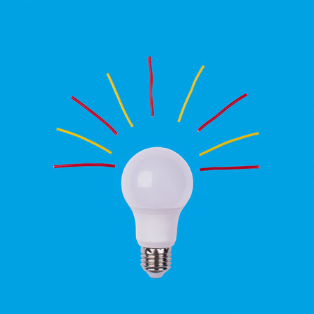 energy saving light bulb on a turquoise backgroundの写真素材
