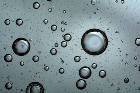 air bubbles in the water. abstract light gray backgroundの写真素材