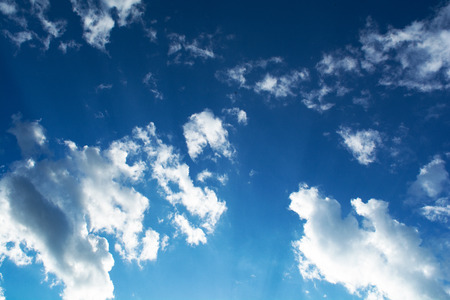 beautiful clouds against a blue sky or the sun makes its way through cumulus cloudsの写真素材