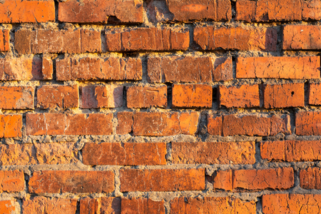background of a red brick wall at sunsetの写真素材