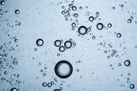 blue background of drops of oil on water