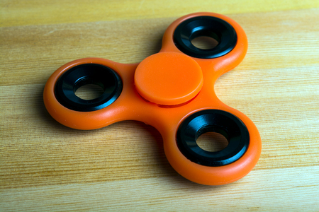 spinner red on a wooden backgroundの写真素材