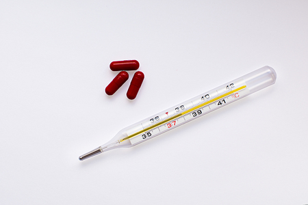 medical thermometer and red tabletsの写真素材