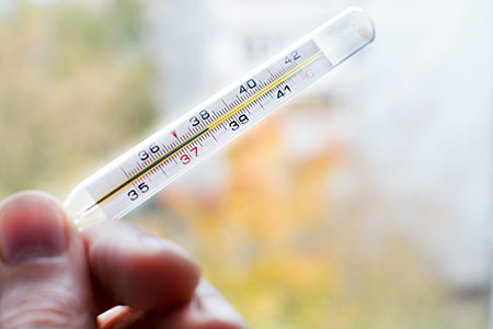 Human hand holding medicine healthcare thermometer