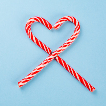 lollipops in the shape of a heart on blue background