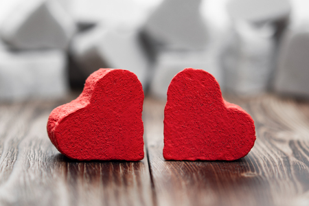 two red hearts on a dark wooden backgroundの写真素材