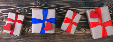 gift boxes with ribbons on wooden backgroundの写真素材