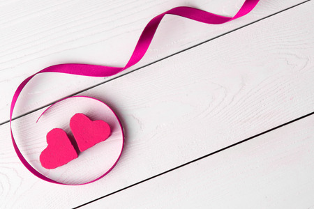 two hearts with ribbon on white backgroundの写真素材