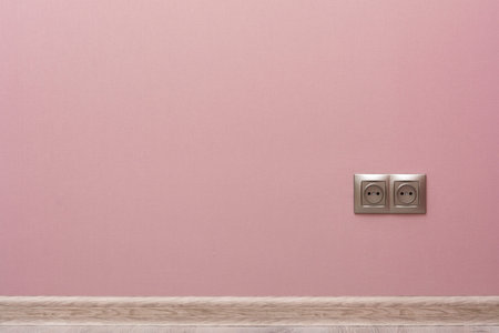 empty pink wall with plinth and socket
