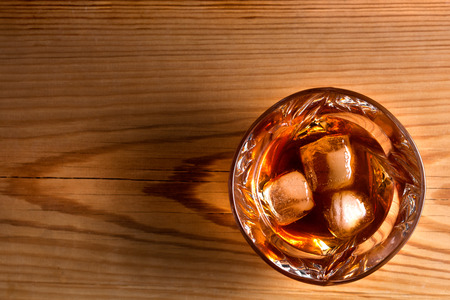 glass of whiskey or cognac on a wooden backgroundの写真素材