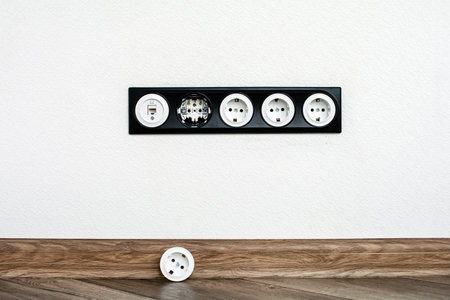 five black white outlet in the white wall