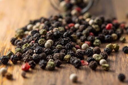 Multicolored peppers mix on a wooden table.の写真素材