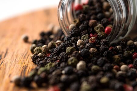 Multicolored peppers mix on a wooden table.の写真素材