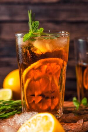 Iced tea with lemon and ice on a wooden backgroundの写真素材