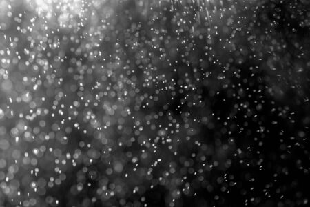 abstract splashes of water or snow on a dark backgroundの写真素材