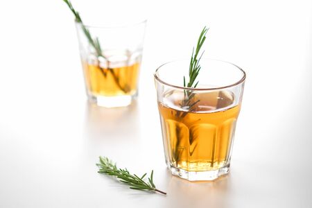 alcoholic drink with lemon and rosemary on a white backgroundの写真素材