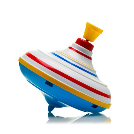 colored spinning top on a white isolated background close-up.の写真素材
