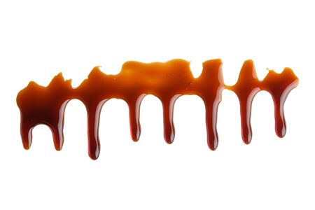 Sweet caramel sauce on a white isolated background close-up. Melted Caramel. Top viewの写真素材