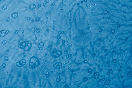 Abstract texture of a dark blue wall with divorces and circles. Decorative putty for concrete with...
