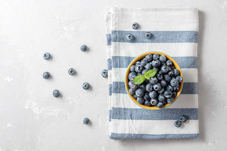 Bowl of blueberries with striped textile on the concrete table with a copy of the space.の写真素材