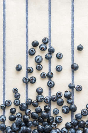 Fresh blueberries on striped textile with a copy of space.の写真素材