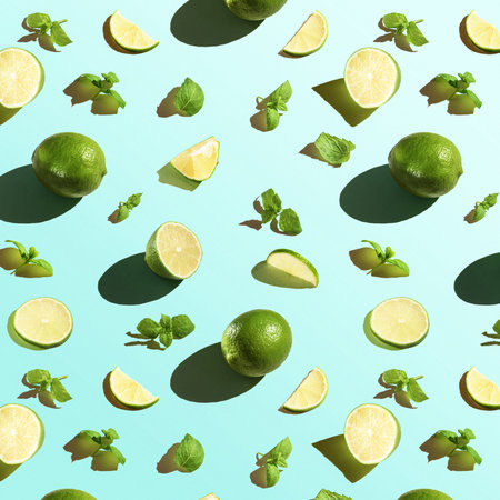 Seamless texture of lime with mint on a blue background. Top view.