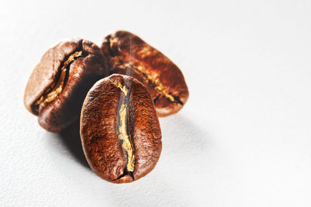 Roasted coffee beans with aromatic smoke on white background.の写真素材