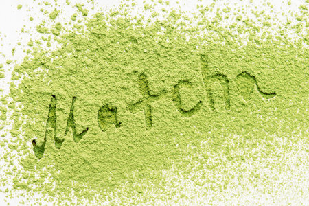 Green matcha tea powder with lettering on a white background.の写真素材