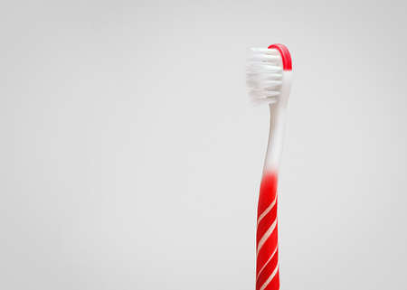 Creative concept of oral hygiene. Toothbrush in the shape of a lollipop on a gray background with copy space.の写真素材