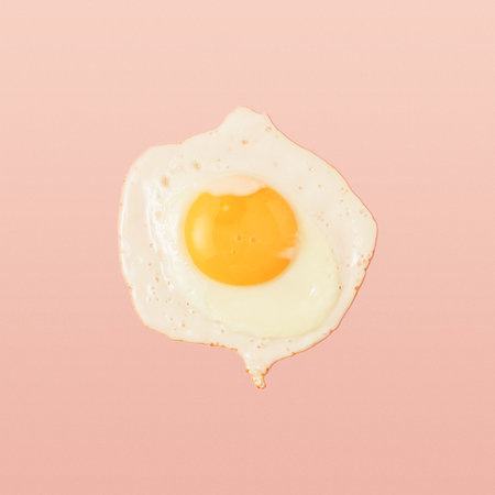Classic scrambled eggs on a pink background. Top view.の写真素材