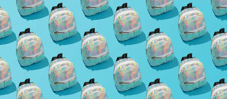 Creative repeating pattern of a school backpack on a blue background.の写真素材
