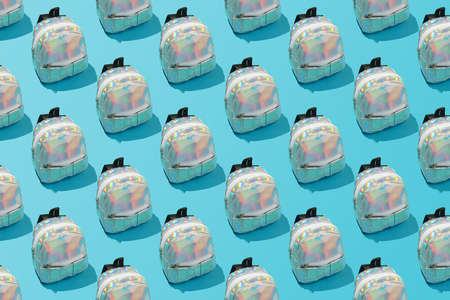 Creative repeating pattern of a school backpack on a blue background.の写真素材