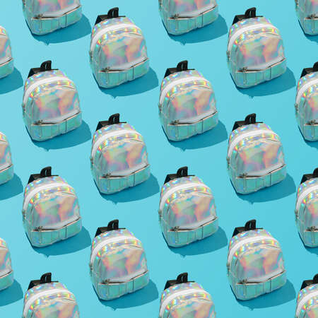 Creative repeating pattern of a school backpack on a blue background.の写真素材