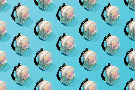 Creative repeating pattern of a school backpack on a blue background.の写真素材