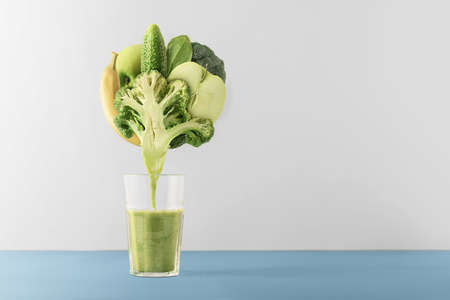 Creative concept for a healthy lifestyle. Set of fruits and vegetables for making smoothies on a gray background.の写真素材
