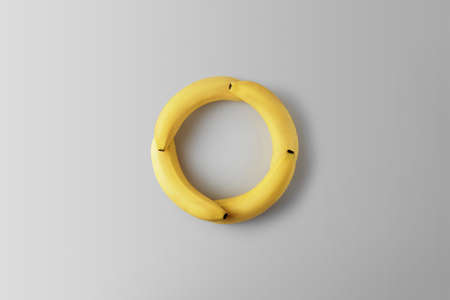 Creative concept zero waste. Bananas in the form of a round on a gray background.の写真素材